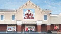 A brown and white two-story building with signs promoting a Christmas store.